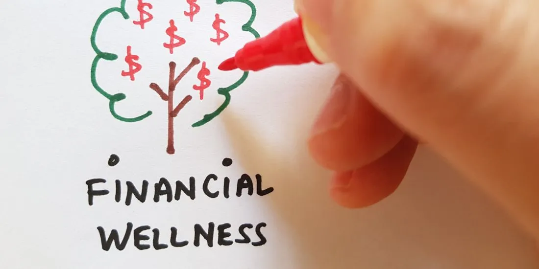 Someone writing Financial Wellness and drawing a tree