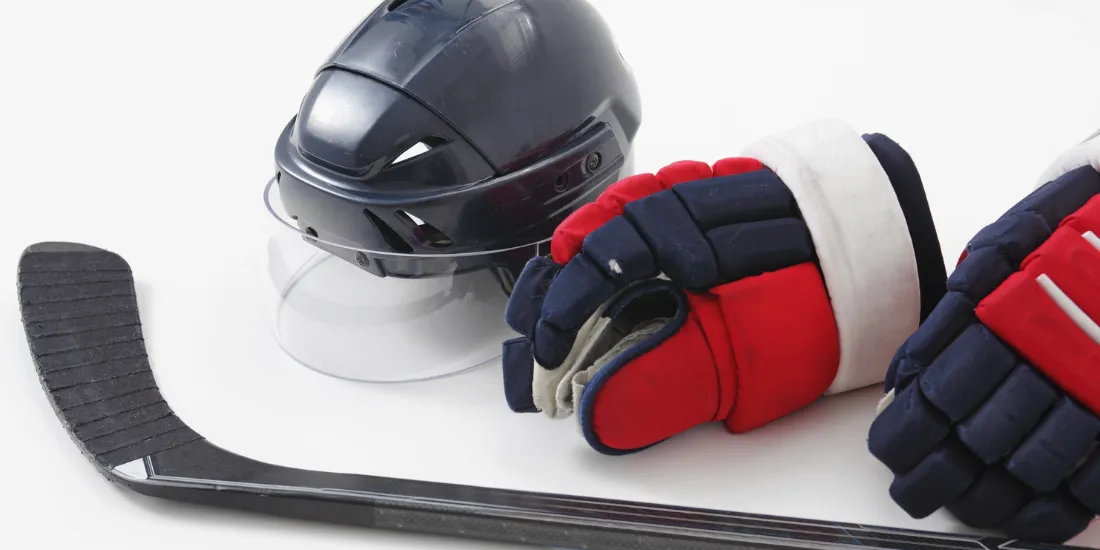 hockey stick and gloves on the ice