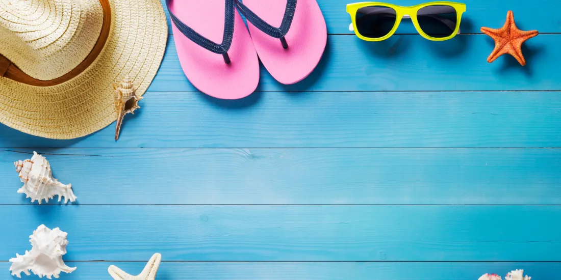 Blue wooden deck with beach themed items on it