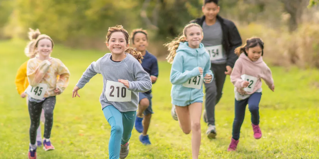 Group of youth run a race during autumn