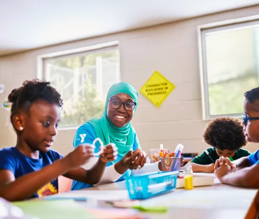 Children playing at a table with pencils