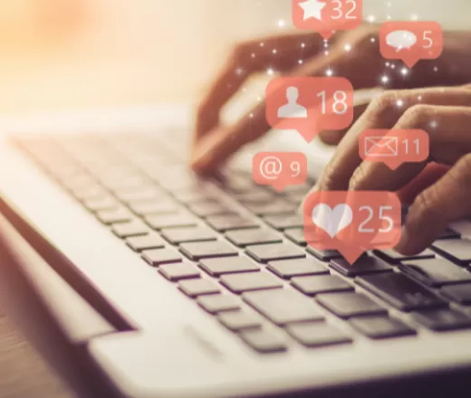 Person on a computer with social icons