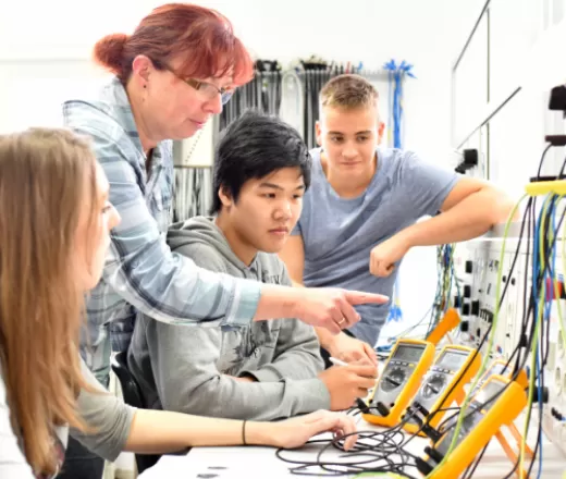 Teacher with students teaching technology