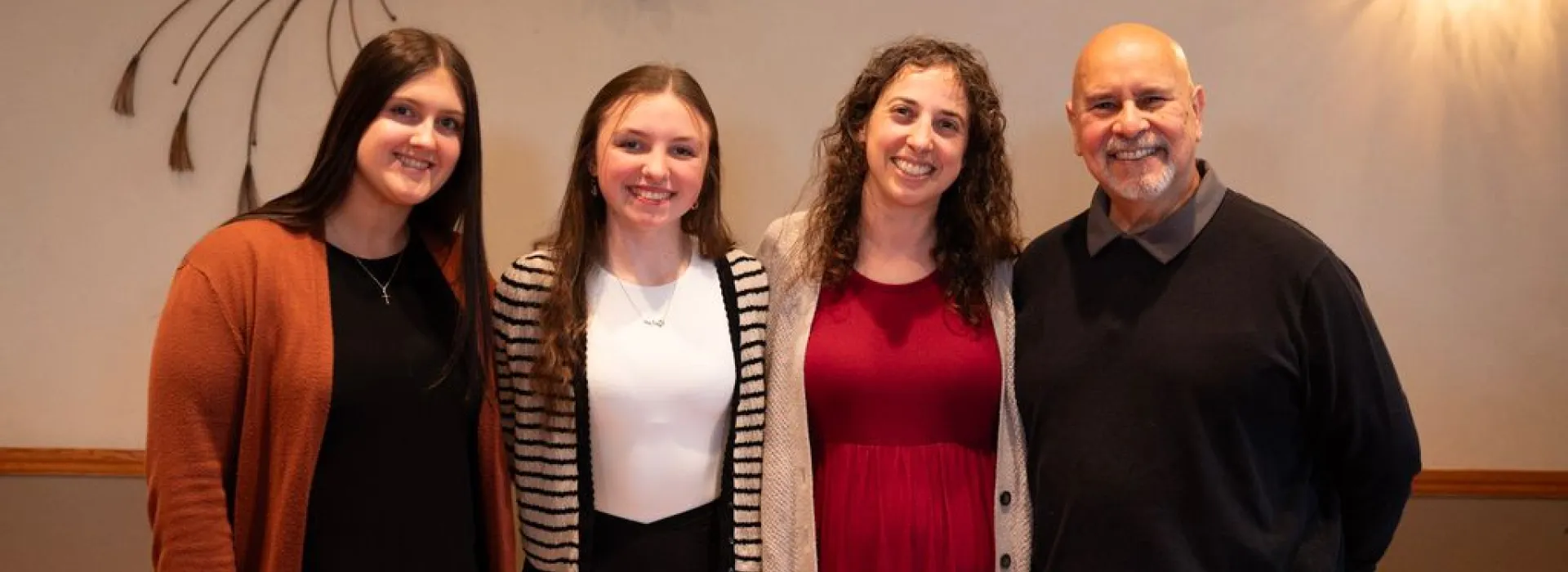 Group of four poses for a photo